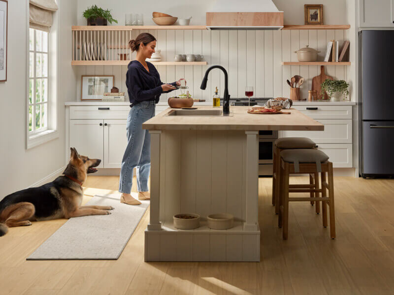 Lady with dog in kitchen | Wacky's Flooring