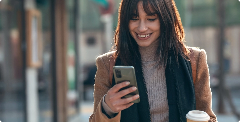 Happy lady looking into mobile | Wacky's Flooring